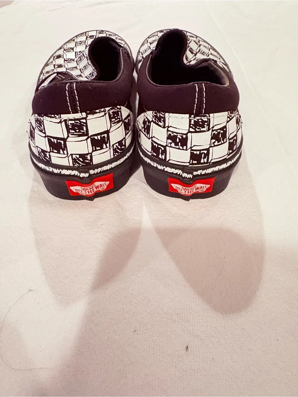Vans Black and White Checkerboard Slip-On Sneakers